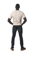 back view of a man standing with his hands in his pockets on white background