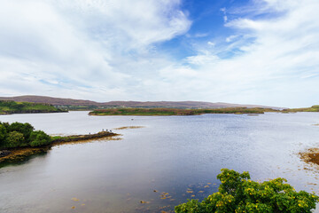 Scottish Highlands landscape showing Summer Isles bay reflecting cloudy sky