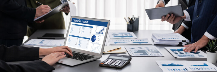 Panorama shot analyst team utilizing BI Fintech to analyze financial report with laptop....