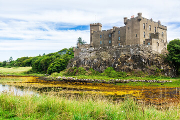 Dunvegan Castle rising on a cliff in the Isle of Skye, Scottish Highlands, Scotland