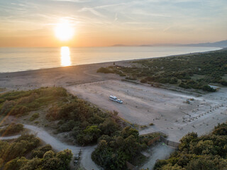 Camper rv caravan on mediterranean coast in Italy. Wild camping on sea shore. Holidays and travel in motor home