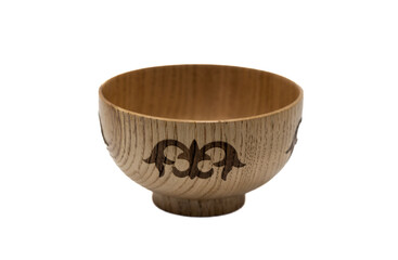 The photo shows a wooden bowl (piала) with a national ornament. It is made of light-colored wood and decorated with a dark carved pattern typical of Kazakh traditional dishware.