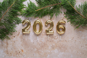 Celebration With Gold Candles Marking the Year 2026 Surrounded by Greenery