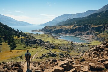 A hiker gazes over a stunning valley merging mountains and water, showcasing the beauty of nature in its diverse forms and inviting exploration and adventure within.