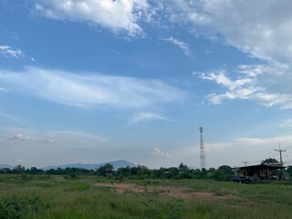 Scenic Landscape with Blue Sky and Green Grass in Rural Area