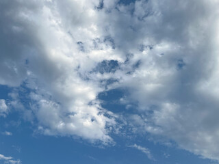 White Cotton Clouds Floating in a Blue Sky with Subtle Texture