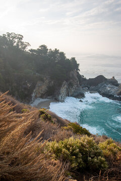 Atmospheric View of McWay Falls on a Moody, Foggy Day Along the Rugged Big Sur Coast in California