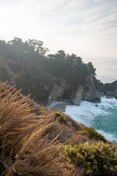 Atmospheric View of McWay Falls on a Moody, Foggy Day Along the Rugged Big Sur Coast in California