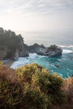 Atmospheric View of McWay Falls on a Moody, Foggy Day Along the Rugged Big Sur Coast in California