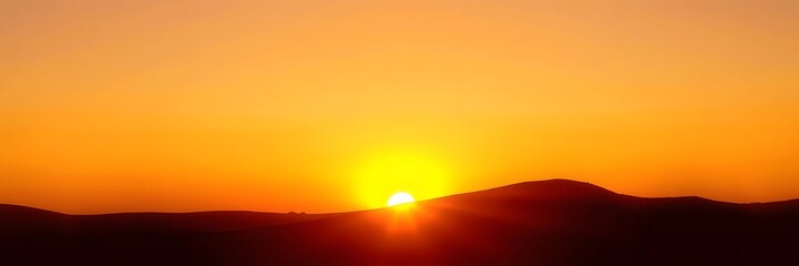 Vibrant sunset over silhouetted mountain range