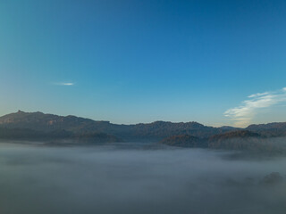 Aerial view scenery sunrise above the sea of mist.Nestled amidst the untouched beauty of Tak Province, Thi Lo Su Waterfall stands tall as a hidden gem within Umphang Wildlife Sanctuary.