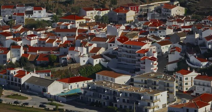 Aerial view of small village with windmill and picturesque rooftops, Odeceixe, Portugal