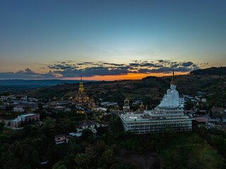 Aerial view amazing Big White Five buddha Statues in sunset. beautiful golden pavilion of Wat Phachonkeaw decorate with jewels and stones on the hill very beautiful and famous landmark in Thailand.