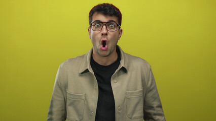 Man with glasses adjusts them on background, spectacles highlight young hispanic features with...