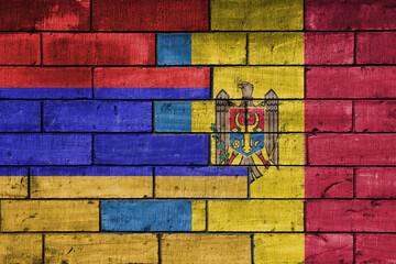 colourful painted big national flag of moldova and flag of armenia on a massive old brick wall background. concept