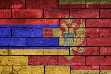 colourful painted big national flag of montenegro and flag of armenia on a massive old brick wall background. concept