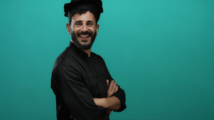 Hispanic man with beard and chef attire smiles confidently against a vibrant green background,...