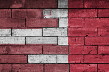 colourful painted big national flag of malta and flag of latvia on a massive old brick wall background. concept