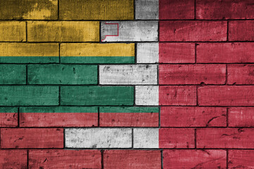 colourful painted big national flag of malta and flag of lithuania on a massive old brick wall background. concept