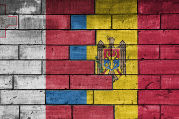 colourful painted big national flag of moldova and flag of malta on a massive old brick wall background. concept
