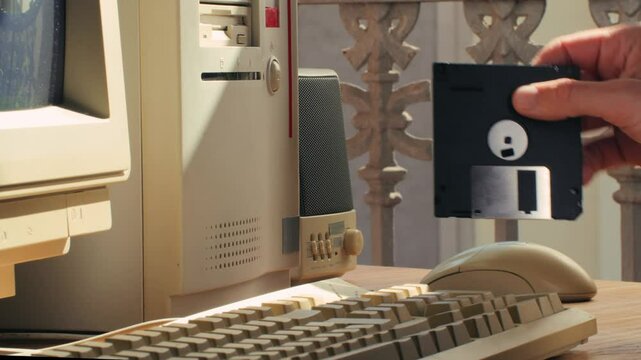 Floppy disc FDD close up, Using diskette for old PC computer macro. Archive programme or Music recorder, playing retro computer games. Vintage device for office, obsolete technology. 