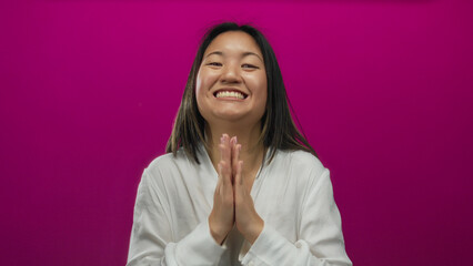 Woman expressing emotions in front of a vibrant pink background featuring isolated expressions,...