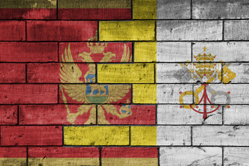 colourful painted big national flag of vatican city and flag of montenegro on a massive old brick wall background. concept