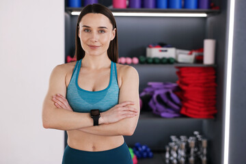 Beautiful woman wearing sportswear in fitness studio, space for text