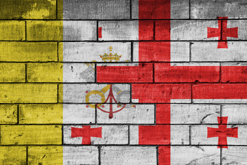 colourful painted big national flag of vatican city and flag of georgia on a massive old brick wall background. concept