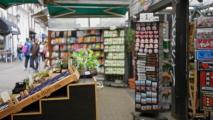 Blurred scene of flower shop display with defocused people in background, showcasing vibrant floral...