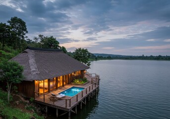 Obraz premium Luxury safari lodge overlooking the vast Serengeti landscape during golden hour. Scenic view of wildlife plains, acacia trees, and open skies in Tanzania.
