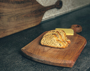A step-by-step view of sandwich preparation with cheese and bread on a kitchen table. Natural textures and light create a warm, inviting image. Ideal for food blogs, recipe sites, or cooking-themed