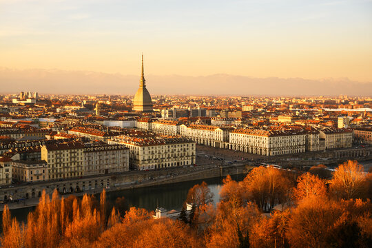 Evening view on the Turin city (Torino) during sunset. Mole Antonellia, Po river and Alps mountains on background. Piedmont, Italy