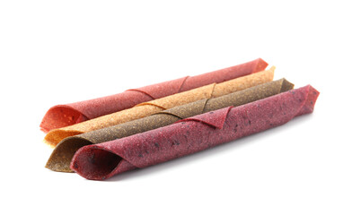 Delicious fruit leather rolls on white background