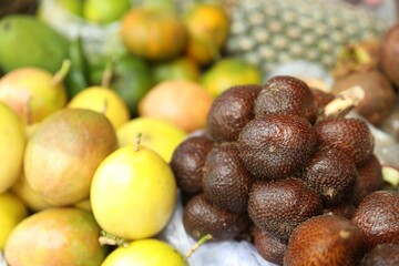 Different fresh exotic fruits at market, closeup
