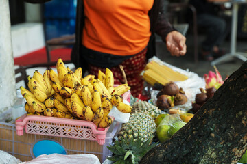 Woman selling different exotic fruits at market, closeup