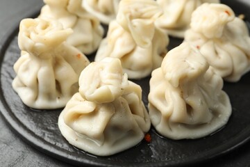 Delicious khinkali with spices on table, closeup