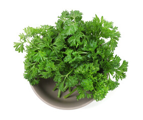 Fresh parsley in bowl isolated on white, top view