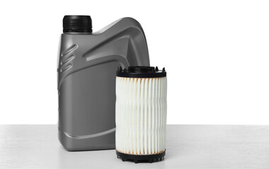 Motor oil in plastic canister and filter isolated on white