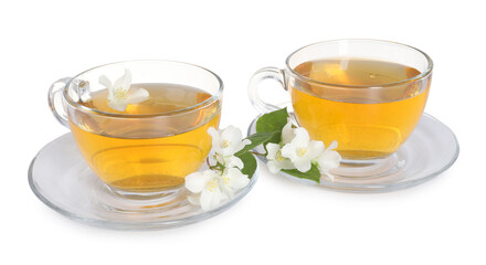 Aromatic jasmine tea in glass cups, flowers and green leaves isolated on white