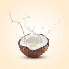 Coconut oil splashing out of nut on beige background
