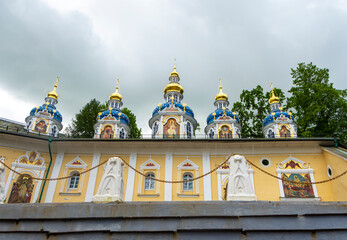 Colorful domes of the Pechora Holy Dormition Pskovo-Pechersky Monastery. Pskov region religion, Christianity history