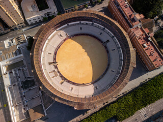 Aerial view of historic circular arena showcasing architectural details and vibrant surroundings, highlighting cultural significance and urban landscape