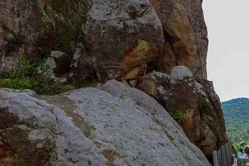 Massive stone rocks with weathered surfaces and protrusions create a majestic, unique relief,...