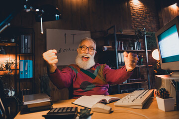 Elderly Programmer Engaged in Remote Work Using a Desktop Computer in a Cozy Office