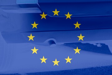 European flag with a car pipe as background.