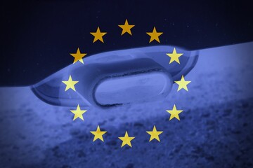 European flag with a car pipe as background.