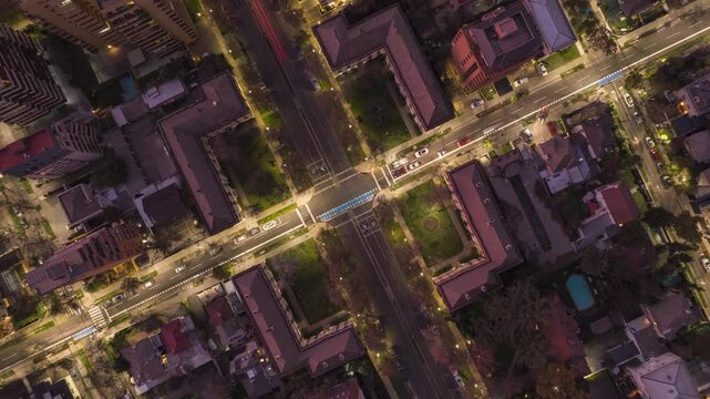 LAS CONDES, CHILE &ndash; AUGUST, 3, 2023. Dynamic hyperlapse: Overhead drone view of urban streets at night. Captures illuminated roads, traffic flow, and residential blocks. Unique top-down city perspecti
