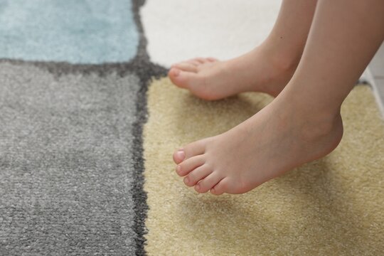 Girl on soft carpet at home, closeup