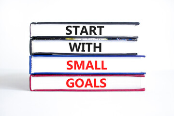 Start with small goals symbol. Concept words phrase Start with small goals on beautiful books....
